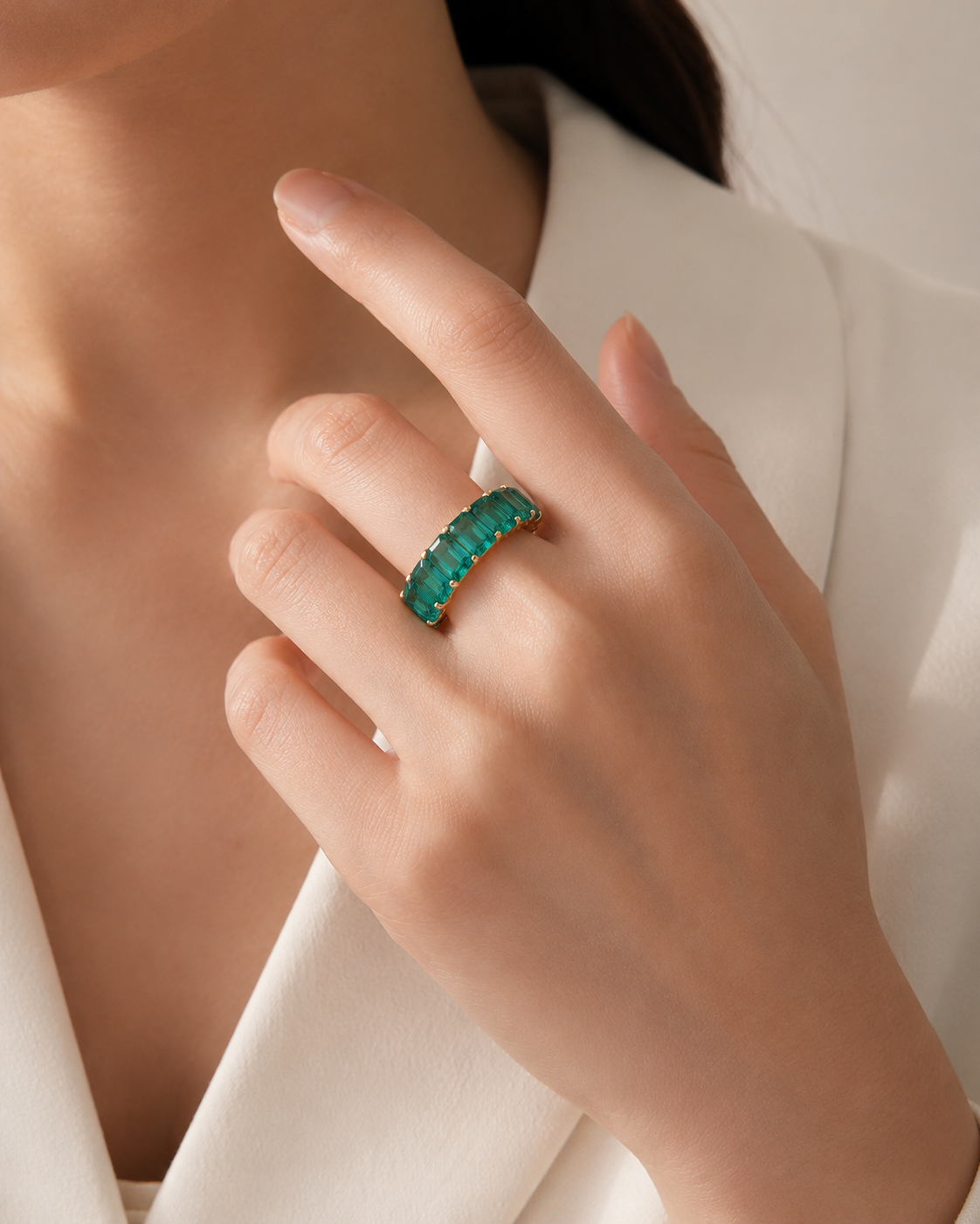 woman wearing lab grown emerald eternity ring