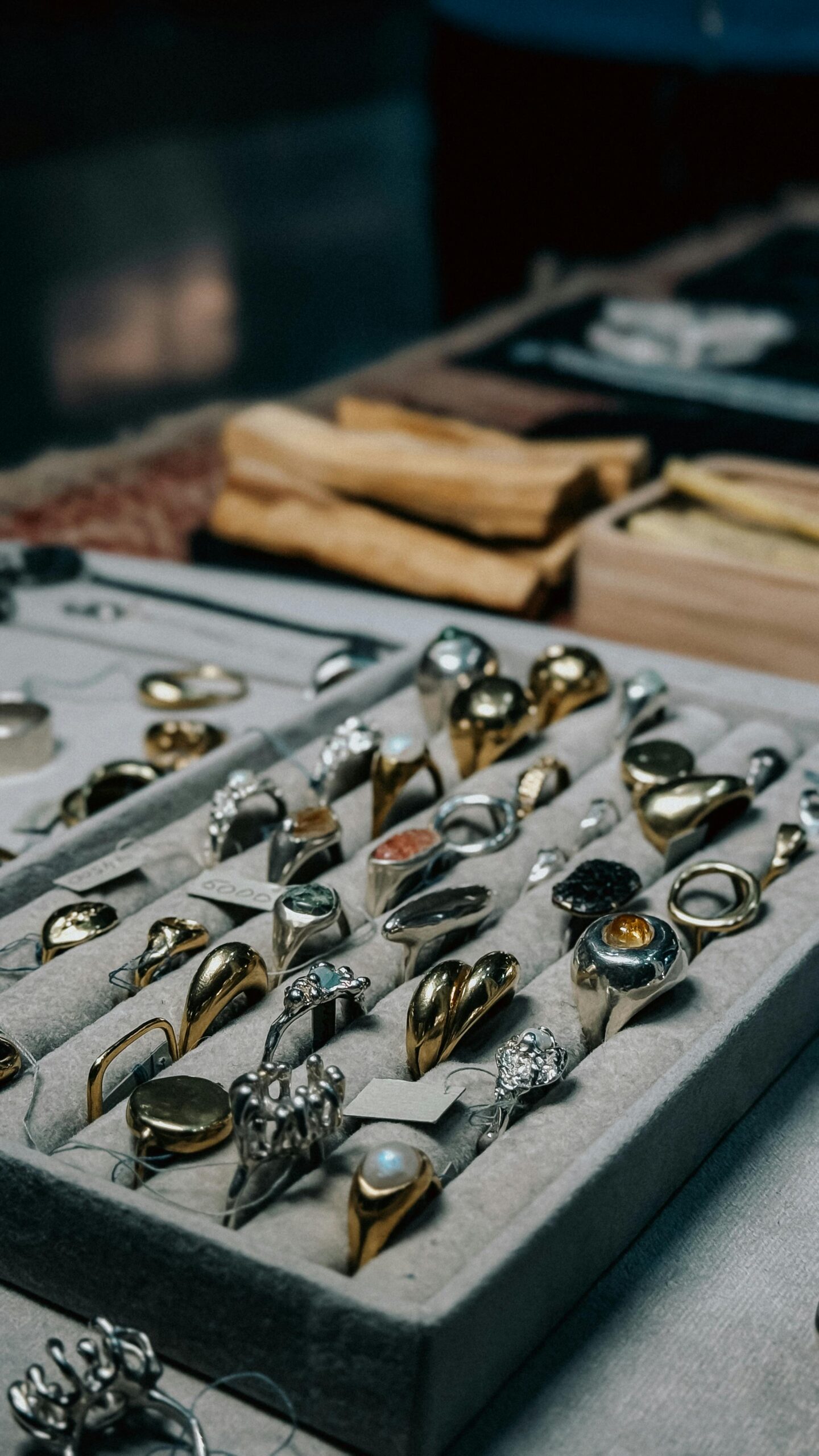 Close-up of a variety of gold and silver rings showcased in a jewelry store setting.